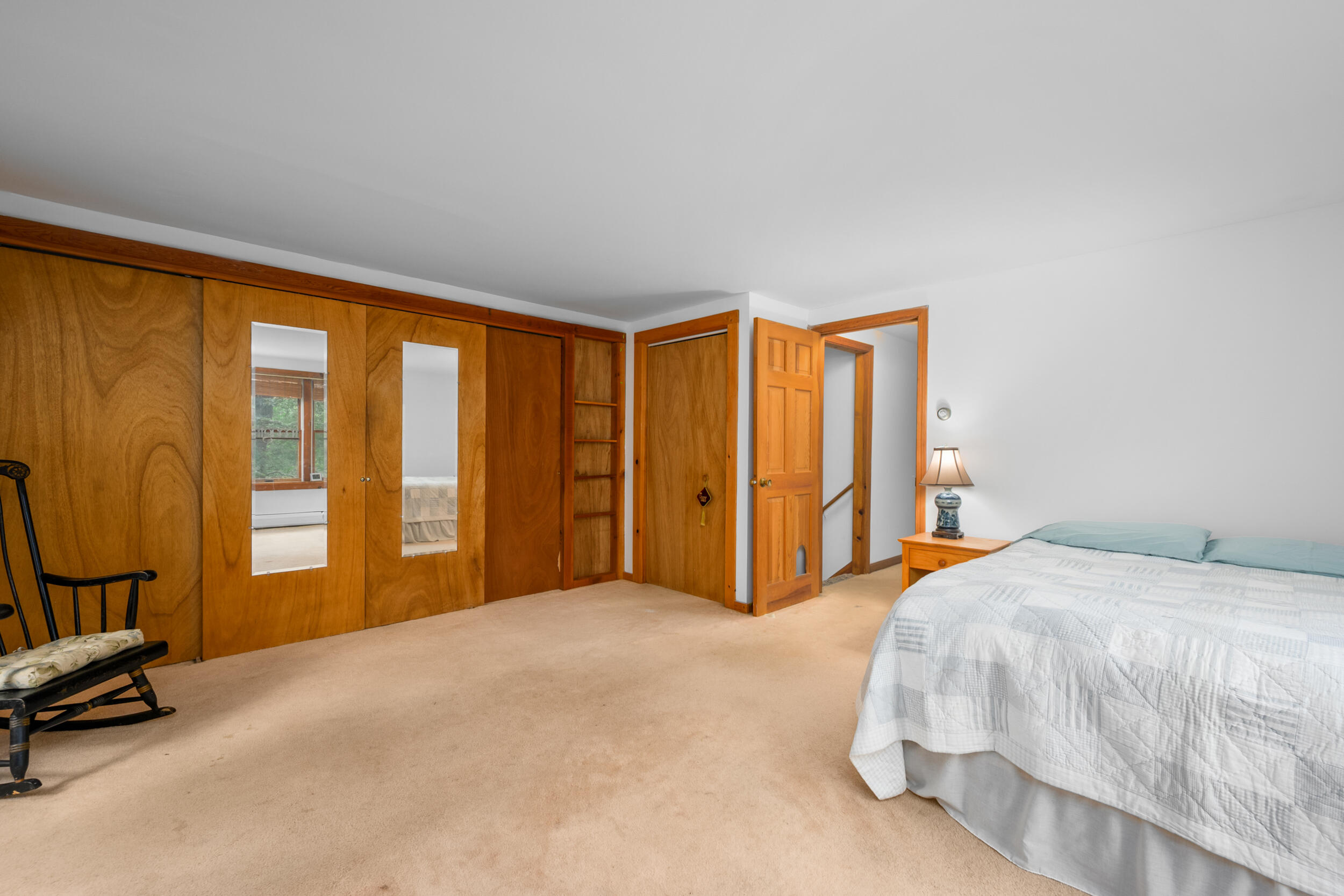 153 Red Fawn Road Brewster, MA 02631 - Photo 19 of 28 a bedroom with a bed and a table in it
