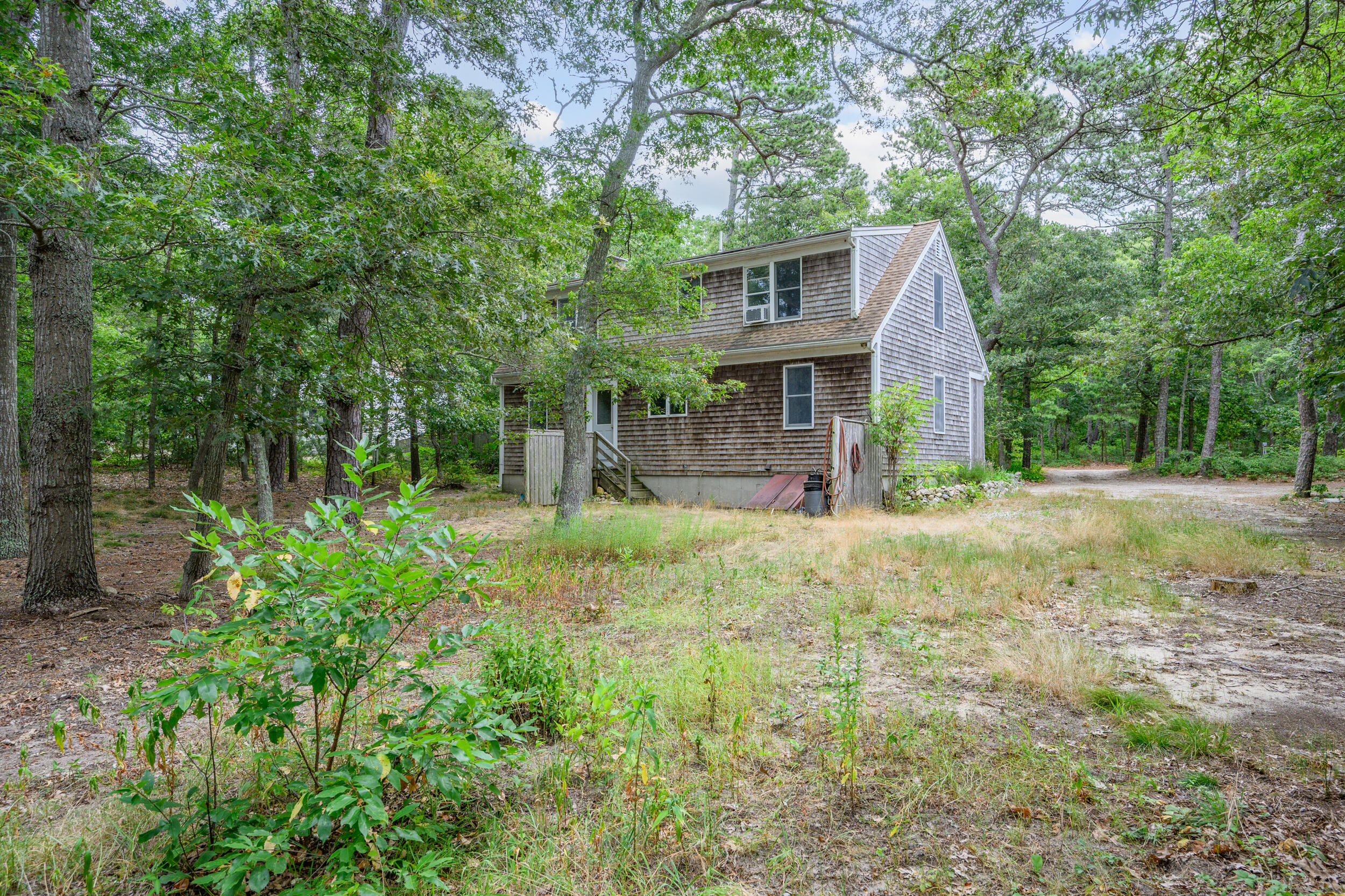 153 Red Fawn Road Brewster, MA 02631 - Photo 26 of 28 a front view of a house with a yard