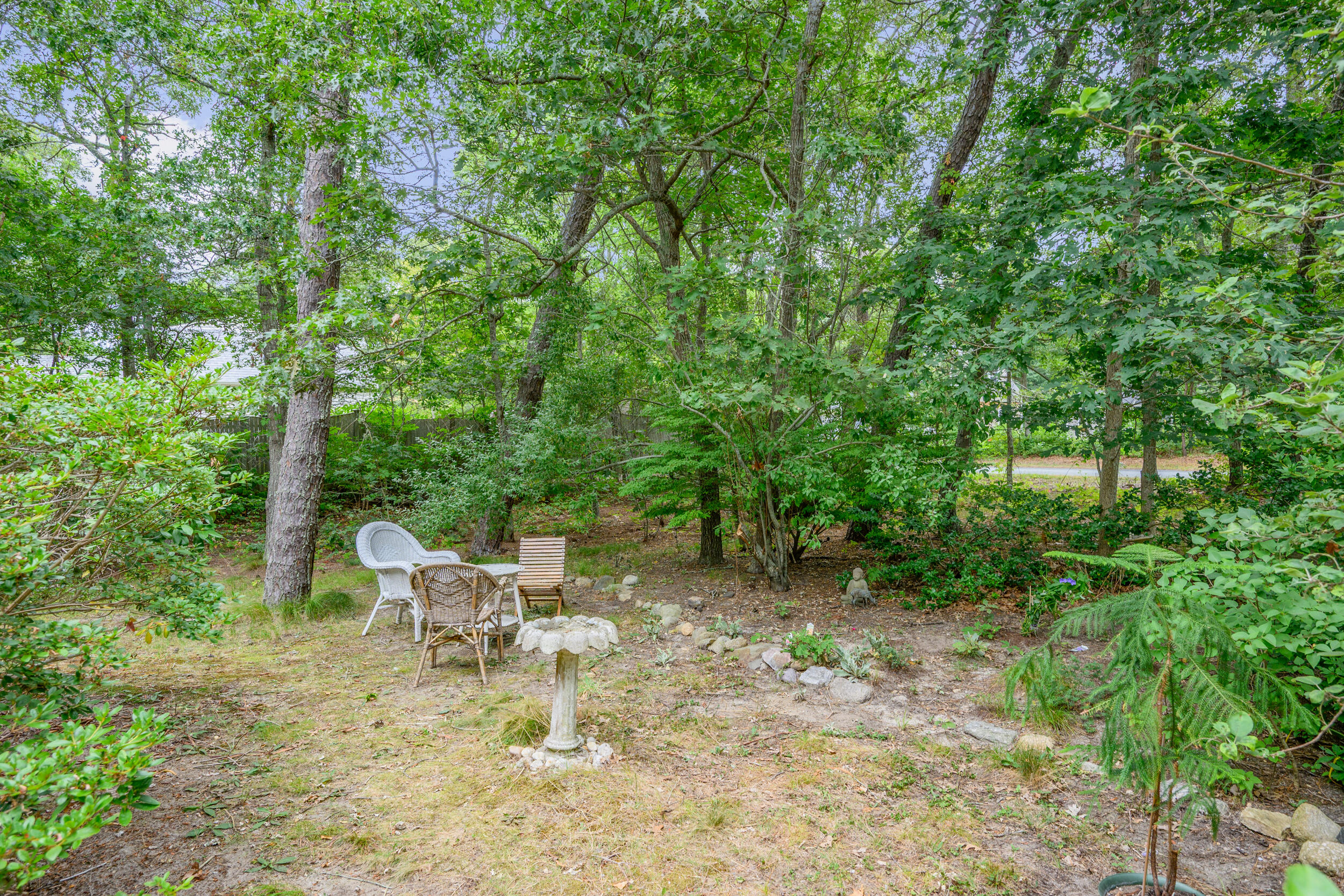 153 Red Fawn Road Brewster, MA 02631 - Photo 28 of 28 a view of a chair and tables in the backyard
