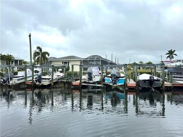 a view of house with yard and lake view