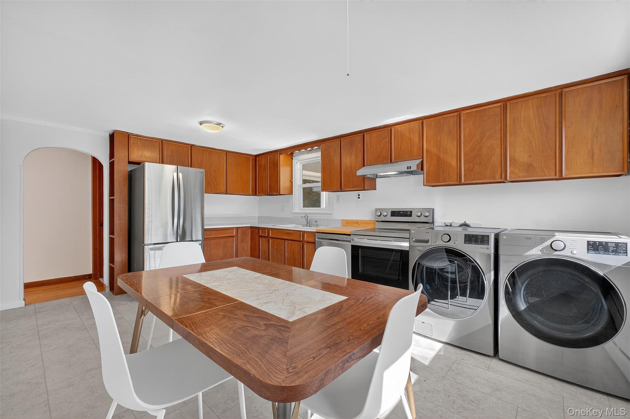 86 Gardnertown Road Newburgh, NY 12550 - Photo 13 of 33 a kitchen with a table chairs sink and cabinets