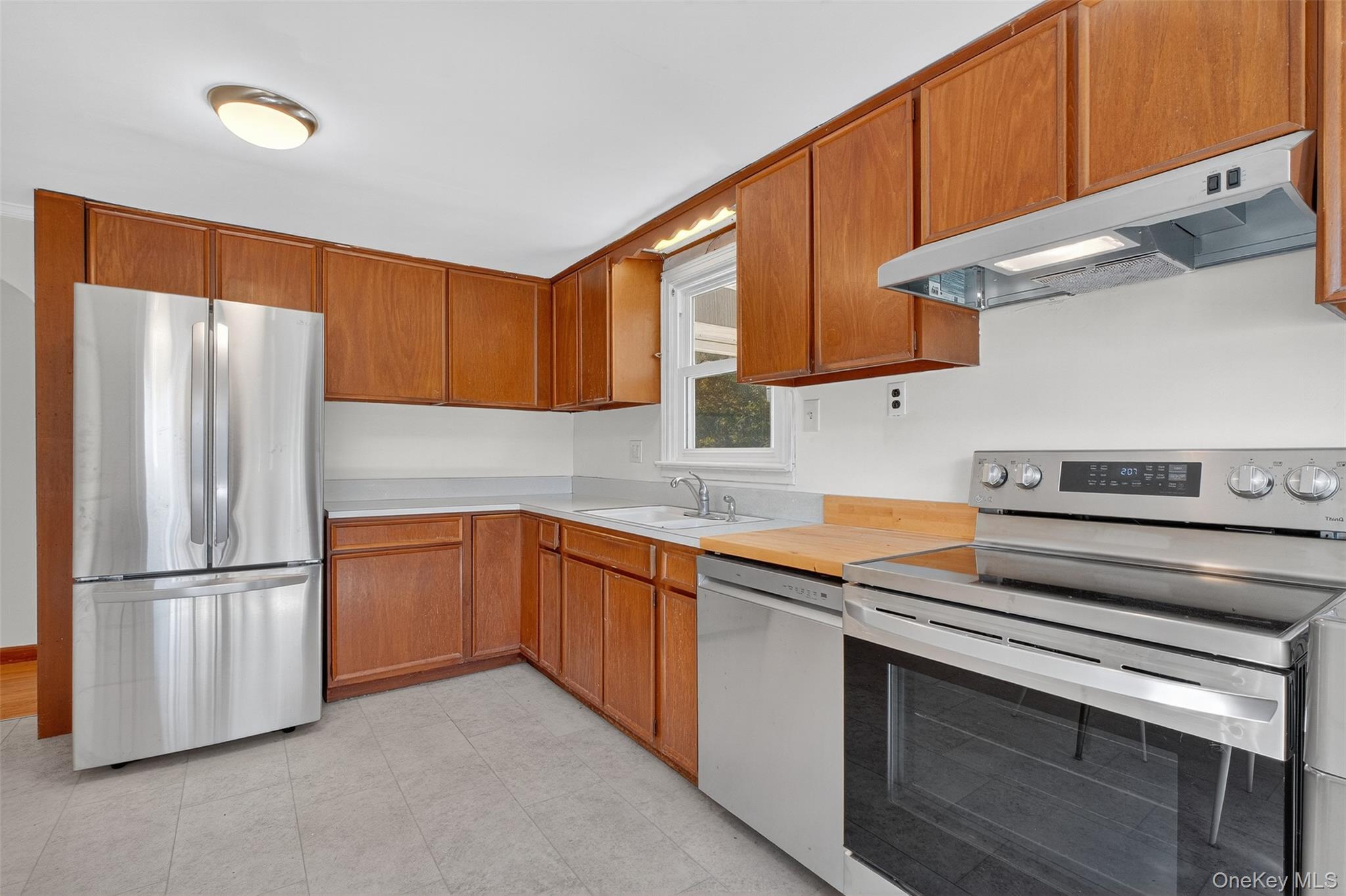 86 Gardnertown Road Newburgh, NY 12550 - Photo 15 of 33 a kitchen with stainless steel appliances granite countertop a refrigerator sink and cabinets