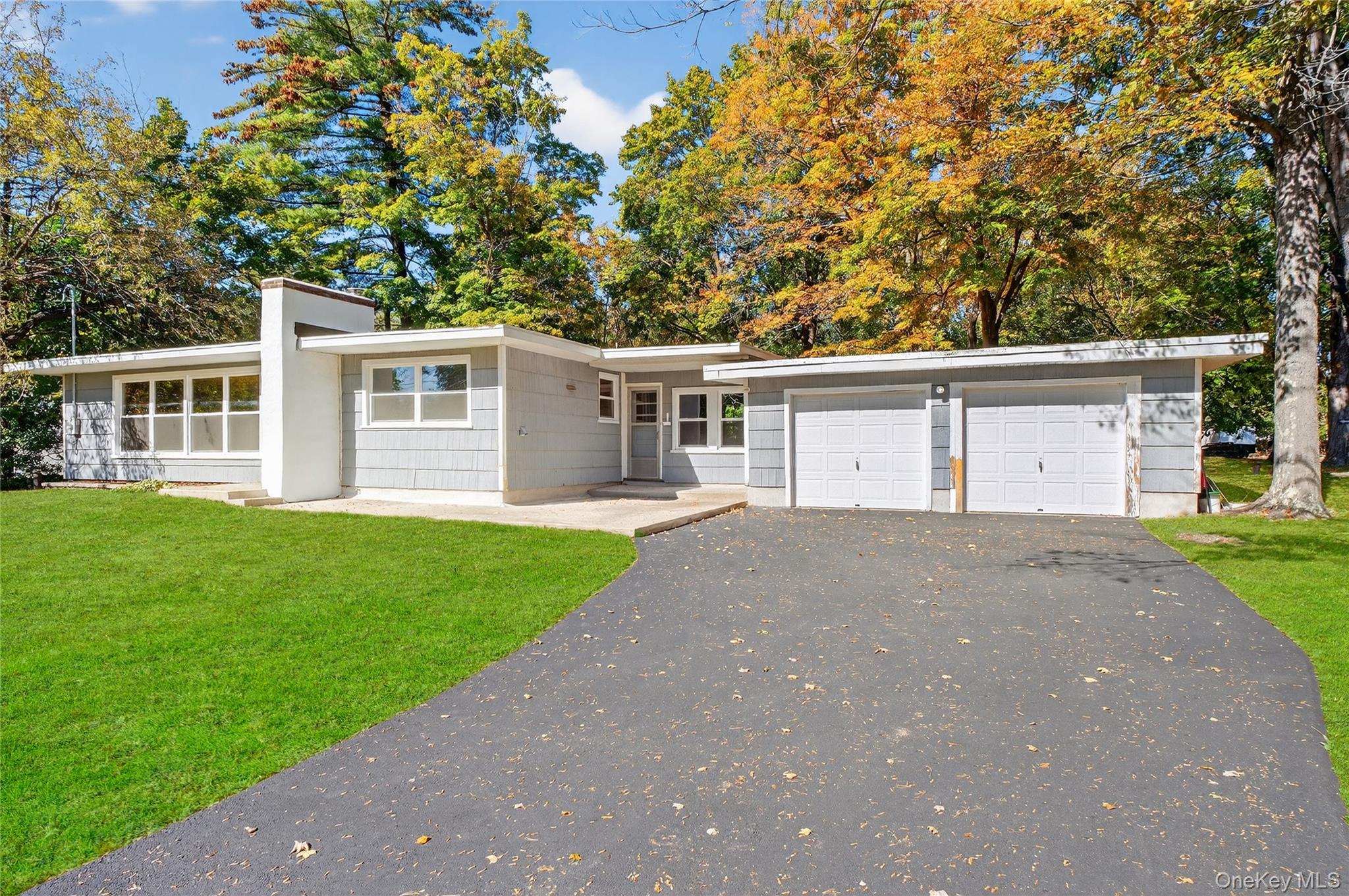 86 Gardnertown Road Newburgh, NY 12550 - Photo 3 of 33 front view of a house with a yard and a garage