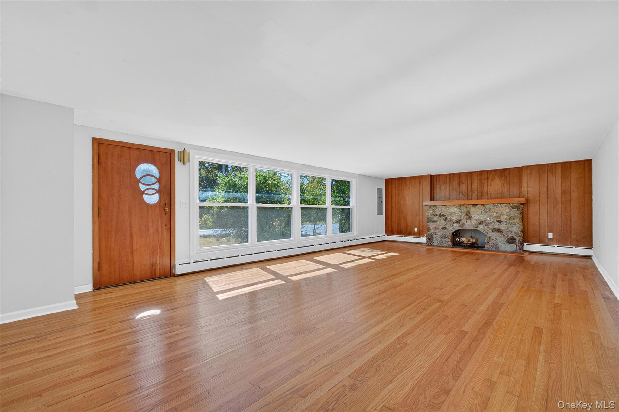 86 Gardnertown Road Newburgh, NY 12550 - Photo 5 of 33 a view of an empty room with wooden floor and a window