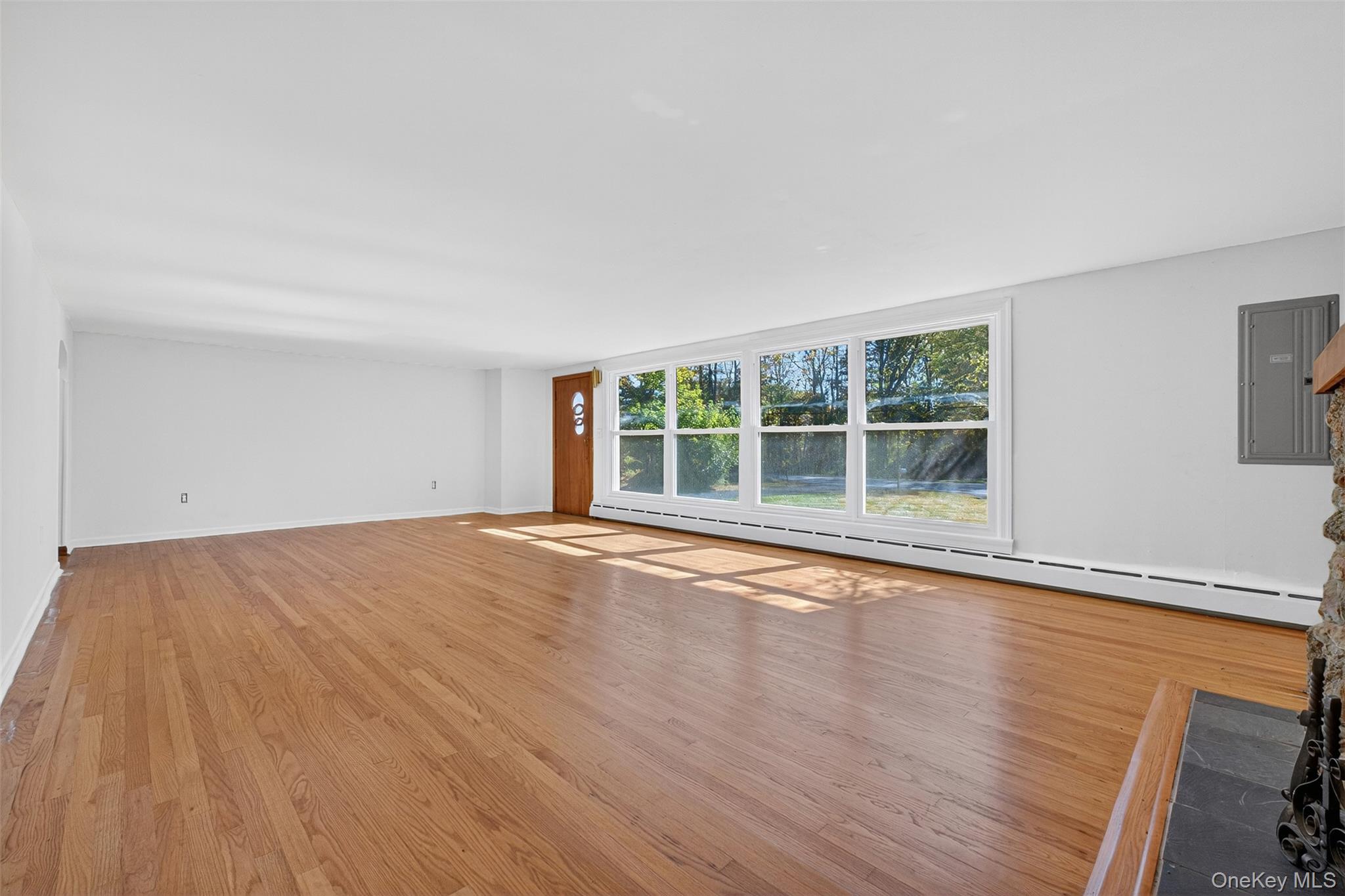 86 Gardnertown Road Newburgh, NY 12550 - Photo 8 of 33 a view of an empty room with wooden floor and a window