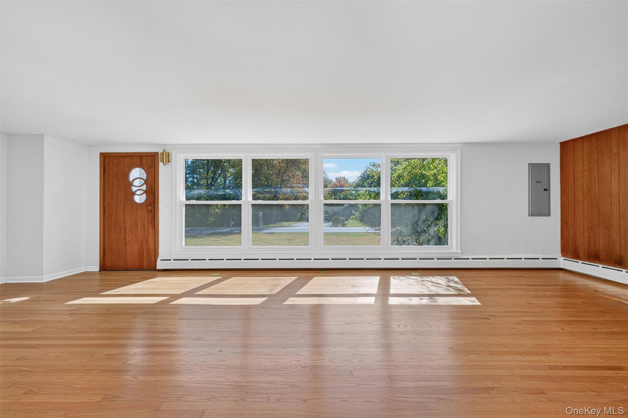 86 Gardnertown Road Newburgh, NY 12550 - Photo 9 of 33 a view of an empty room with wooden floor and a window
