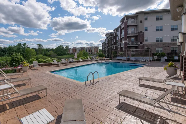 a view of swimming pool with outdoor seating and a tub
