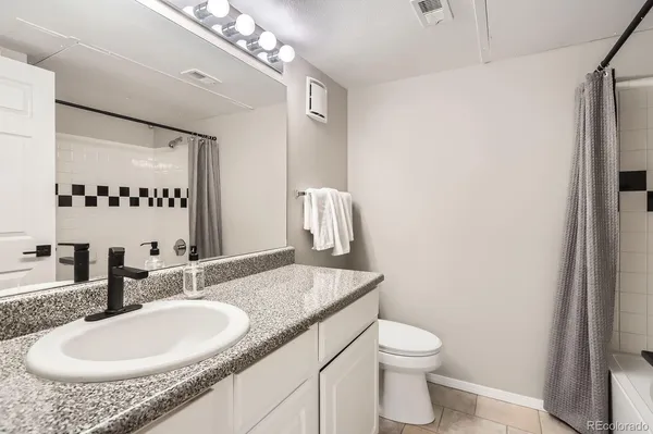 a view of bathroom with a shower and a sink