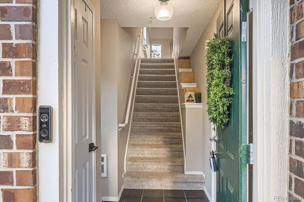 a view of entryway with wooden floor and stairs