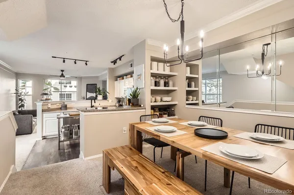 a kitchen with kitchen island granite countertop a sink cabinets and wooden floor
