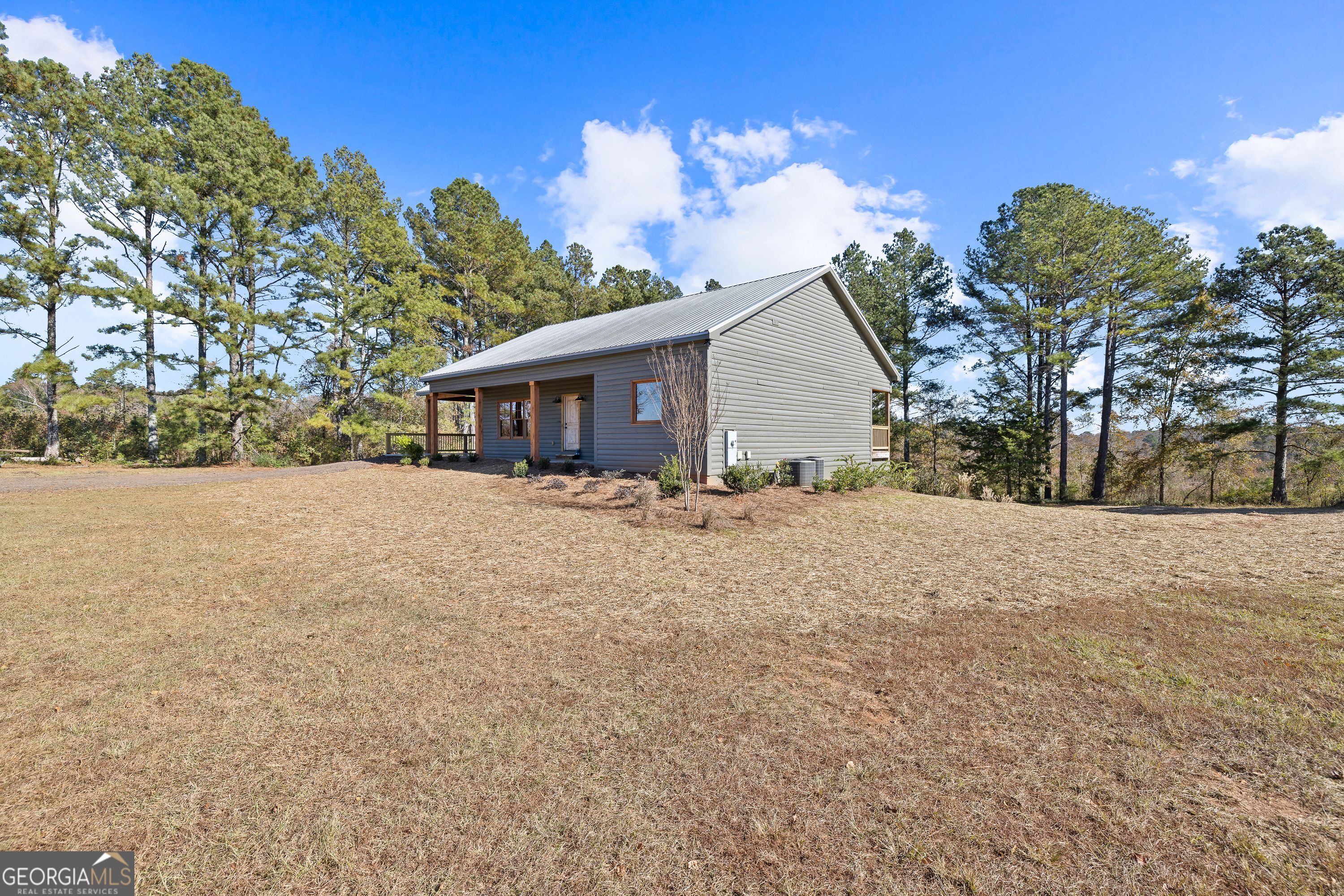 130 North Wesley Chapel Road Eatonton, GA 31024 - Photo 16 of 45 a view of house with yard and a large tree