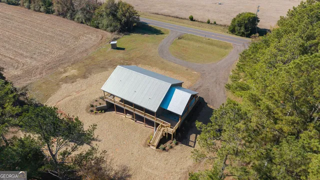 an aerial view of a house with a yard and sitting area