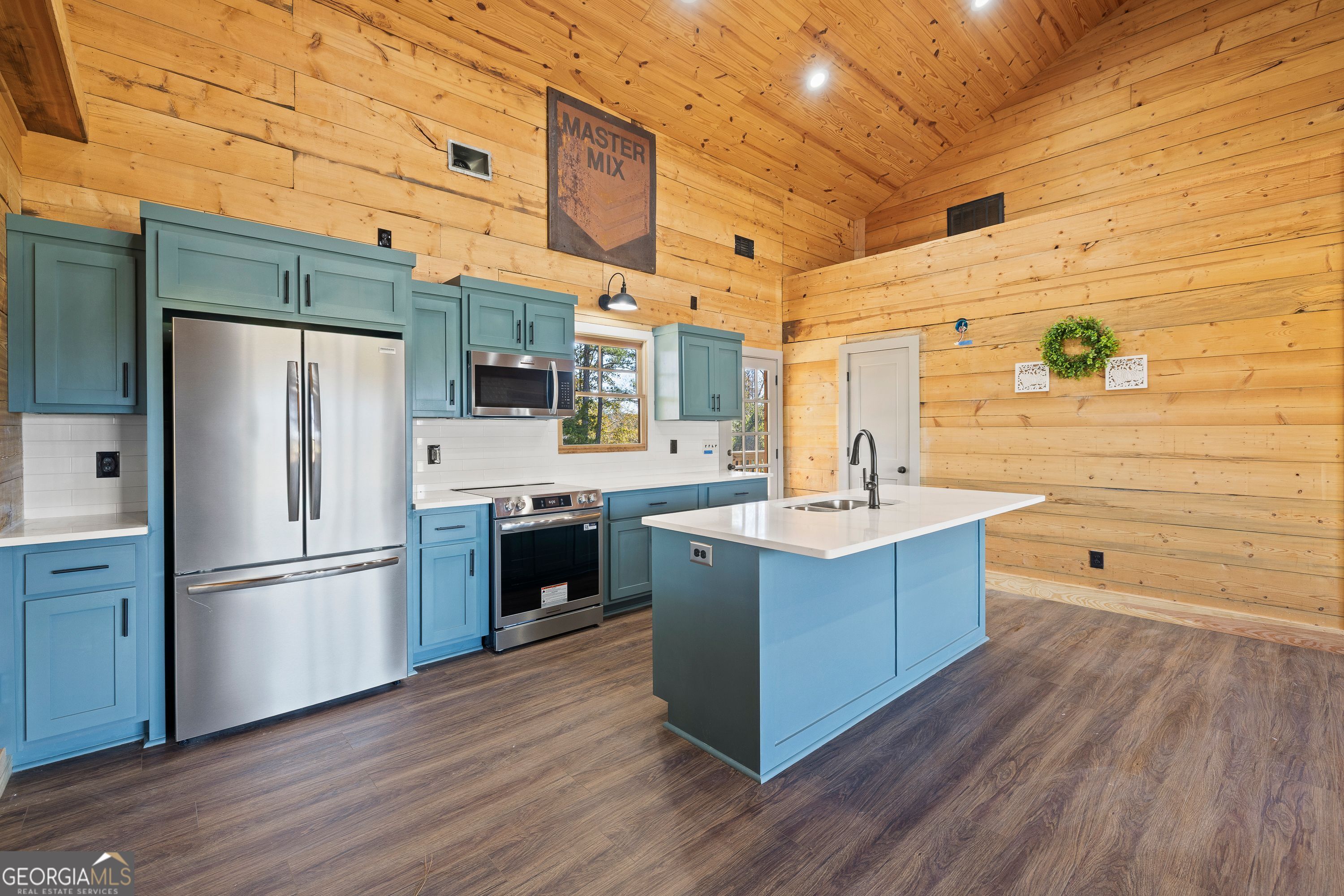 130 North Wesley Chapel Road Eatonton, GA 31024 - Photo 21 of 45 a kitchen with stainless steel appliances a sink cabinets and wooden floor