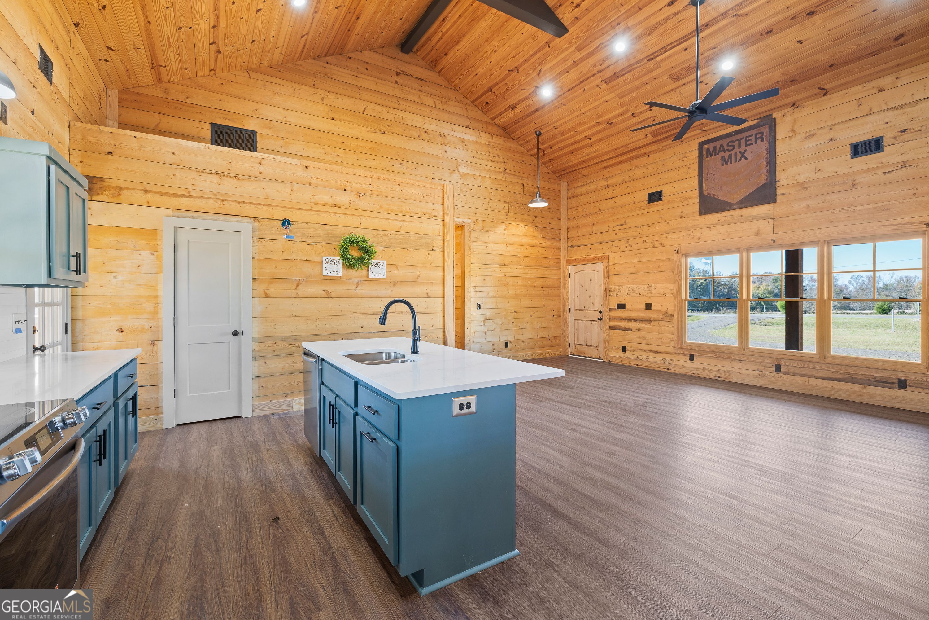 130 North Wesley Chapel Road Eatonton, GA 31024 - Photo 23 of 45 a kitchen with sink cabinets and wooden floor