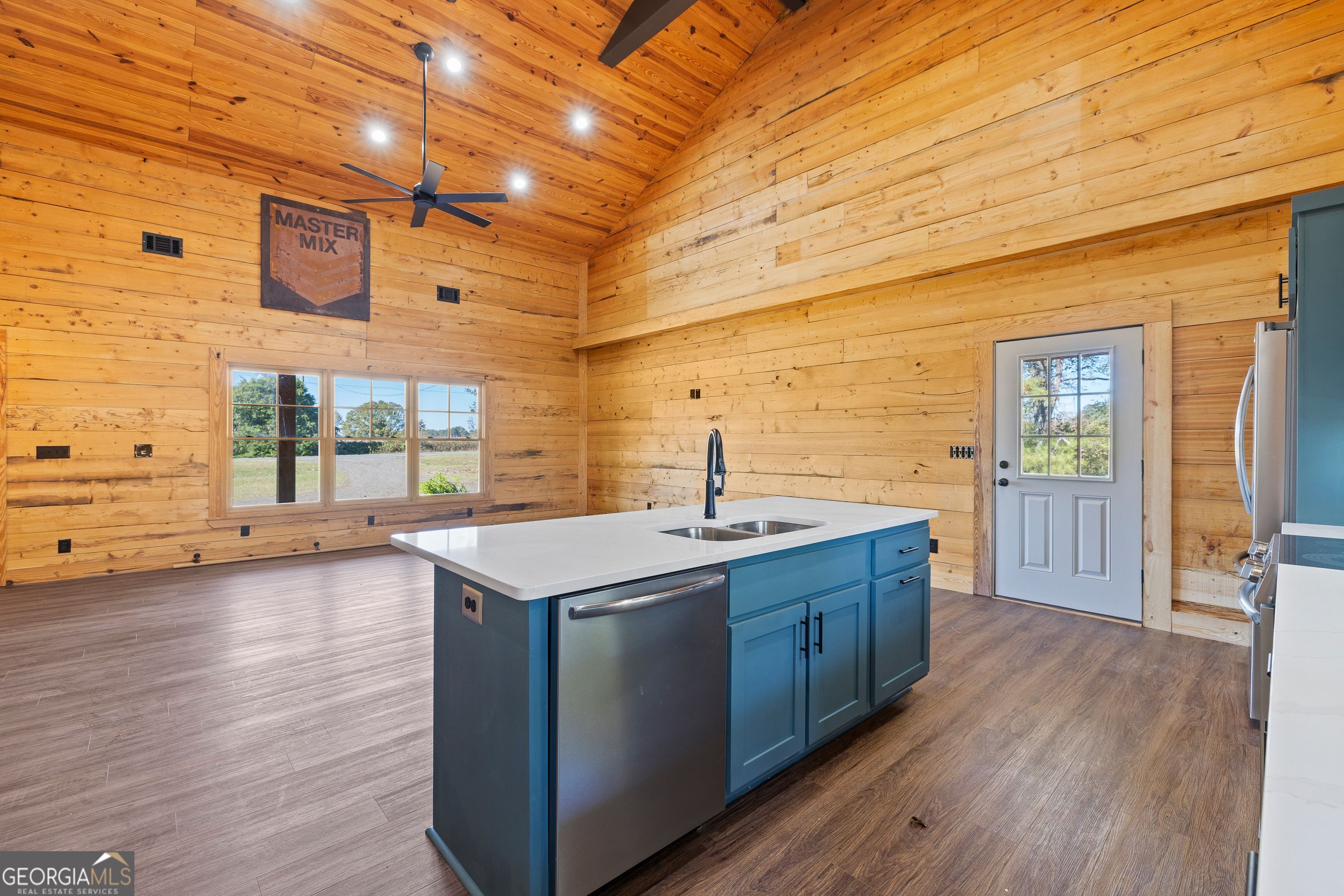 130 North Wesley Chapel Road Eatonton, GA 31024 - Photo 24 of 45 a kitchen with sink cabinets and wooden floor