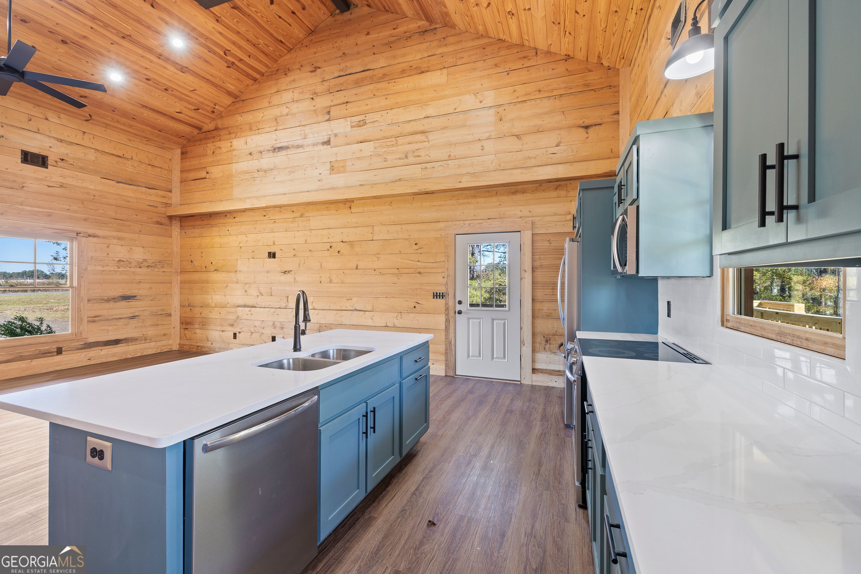 130 North Wesley Chapel Road Eatonton, GA 31024 - Photo 25 of 45 a view of a kitchen with a sink and wooden floor
