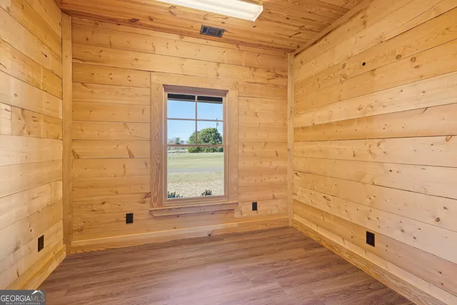 a view of a brick wall with wooden floor and a window
