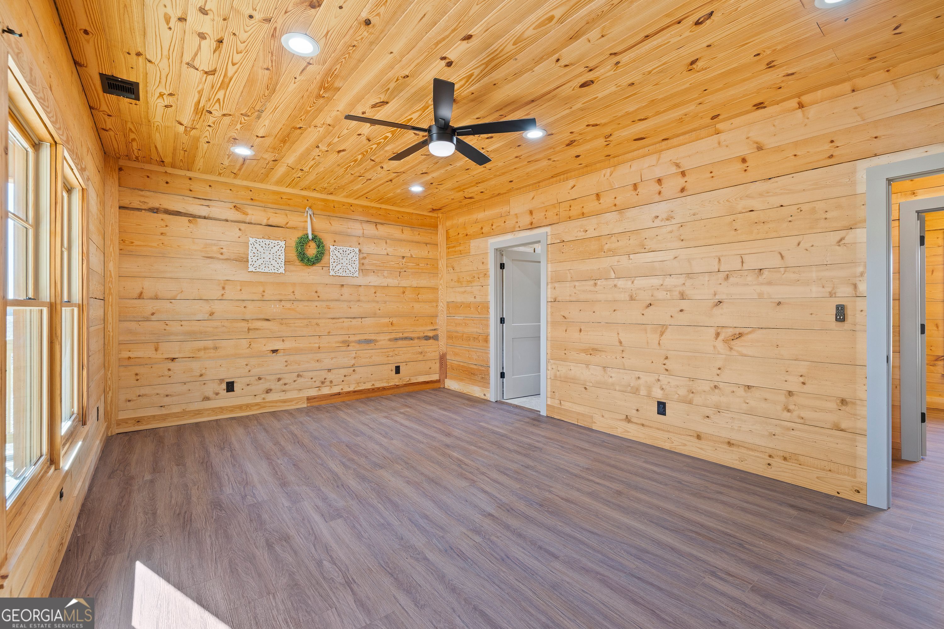 130 North Wesley Chapel Road Eatonton, GA 31024 - Photo 30 of 45 a view of an empty room with wooden floor and a window