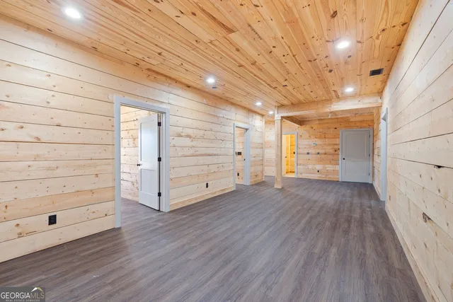 a view of an empty room and wooden floor