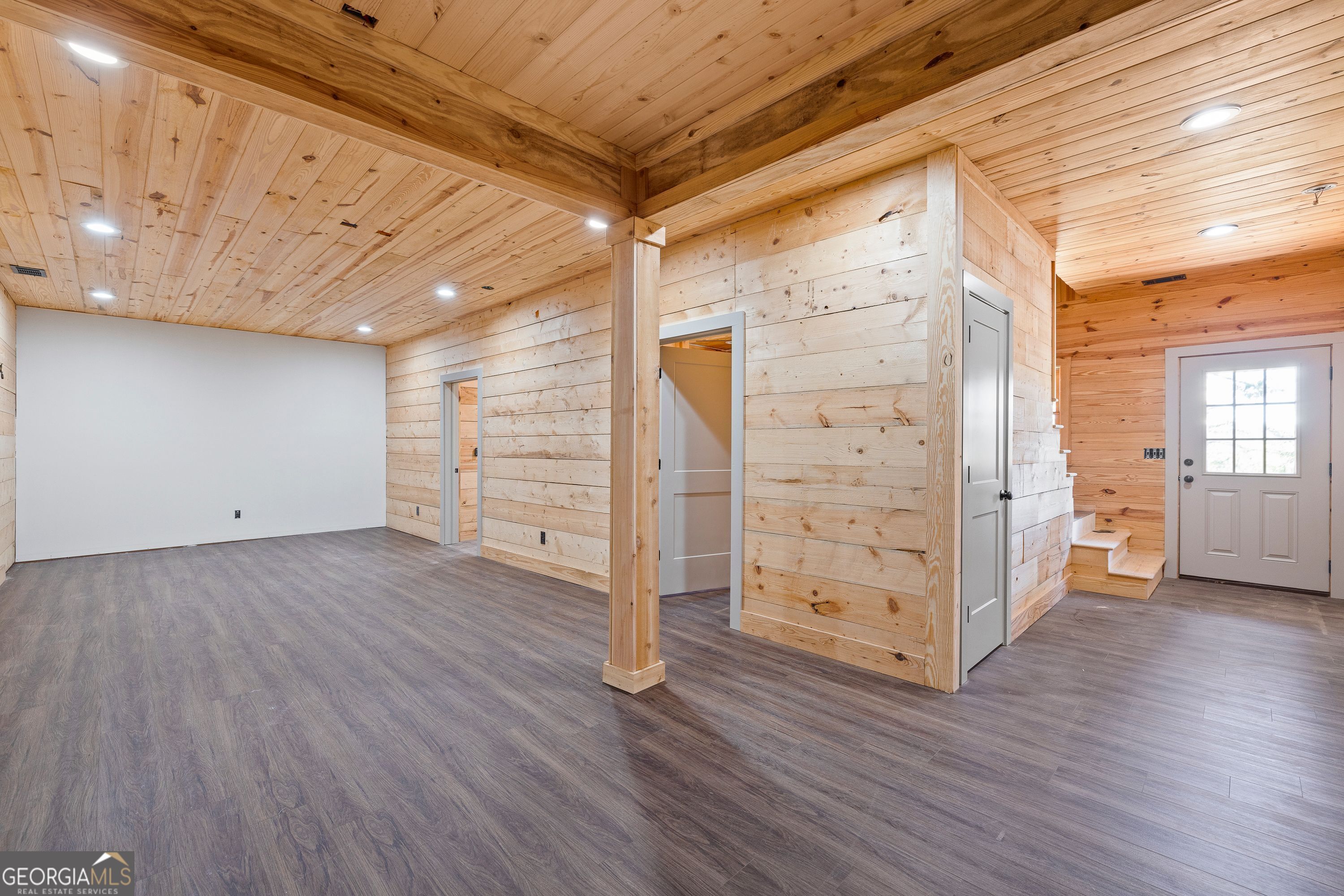 130 North Wesley Chapel Road Eatonton, GA 31024 - Photo 41 of 45 a view of an empty room with wooden floor and windows