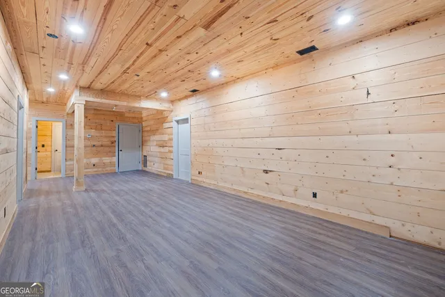 a view of empty room with wooden floor