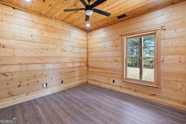 a view of a room with window and wooden floor