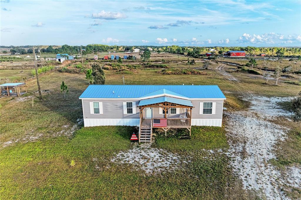 an aerial view of a house with a yard