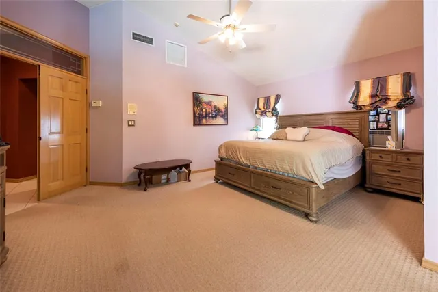 a room with a bed cabinets and a window