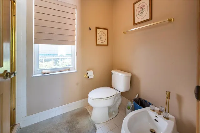 a view of a patio with table and chairs with potted plants and wooden fence