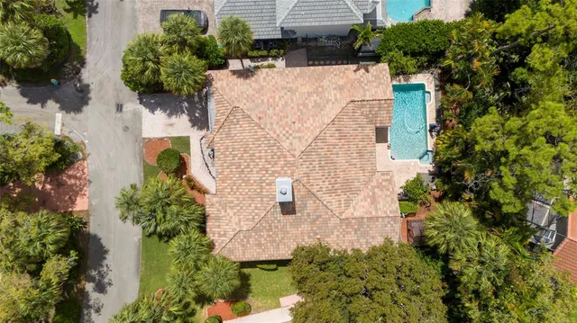 an aerial view of a house with a yard