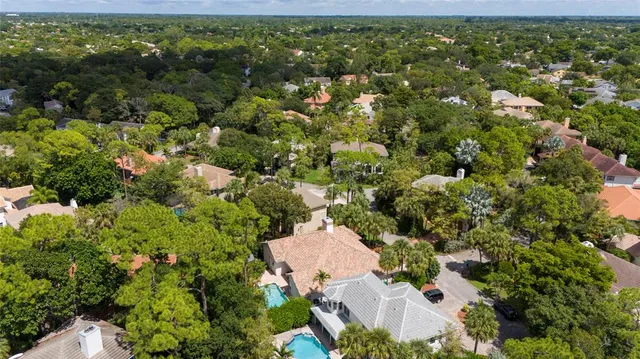 an aerial view of a house with a yard and outdoor seating