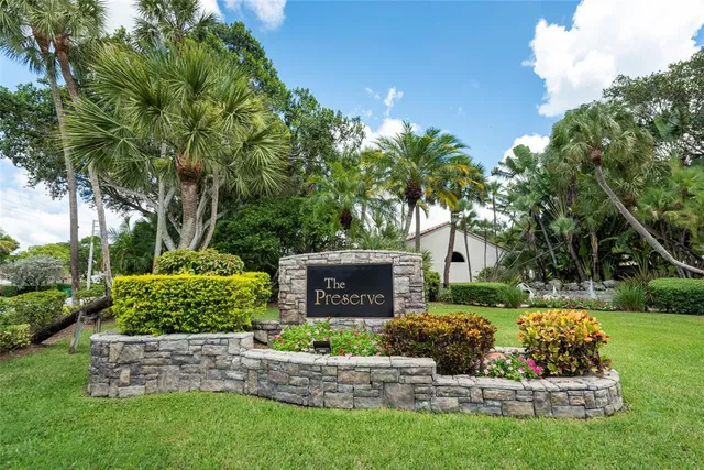 front view of a house with a yard and potted plants