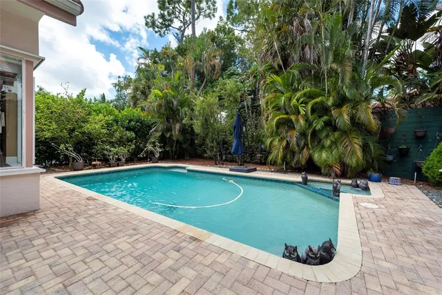 a view of a swimming pool with an outdoor space and seating area