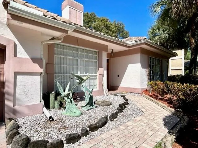 a aerial view of a house with a yard and potted plants