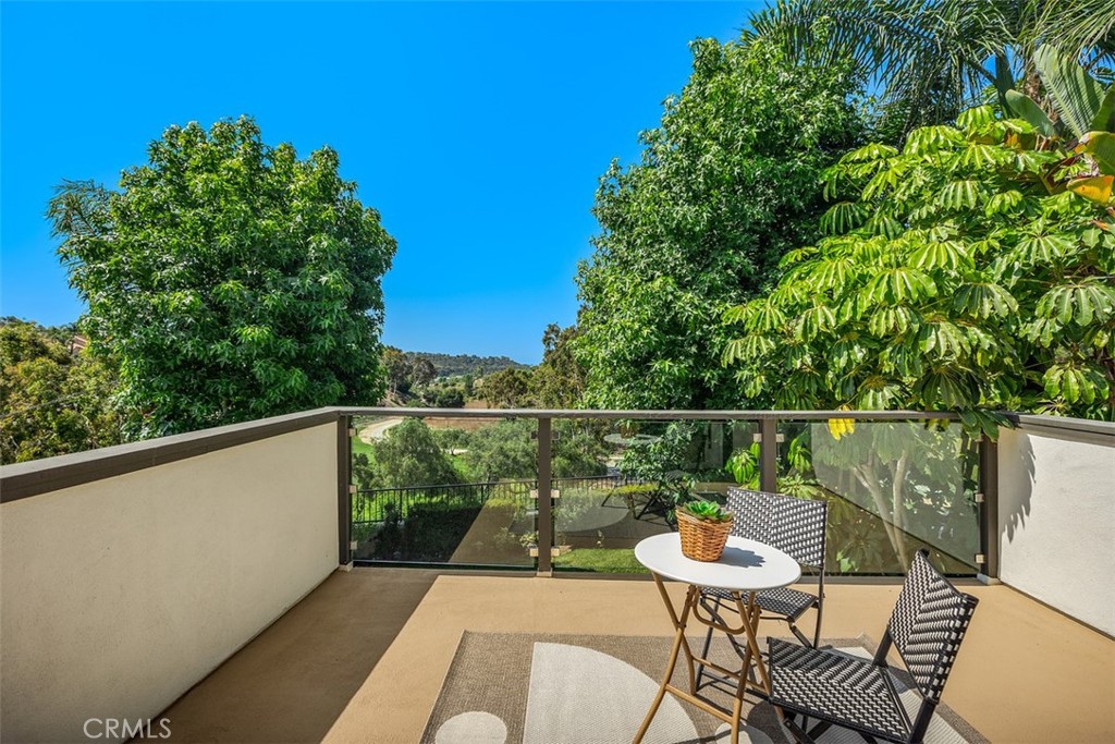6 Calella Laguna Niguel, CA 92677 - Photo 17 of 28 a balcony with a table and chairs