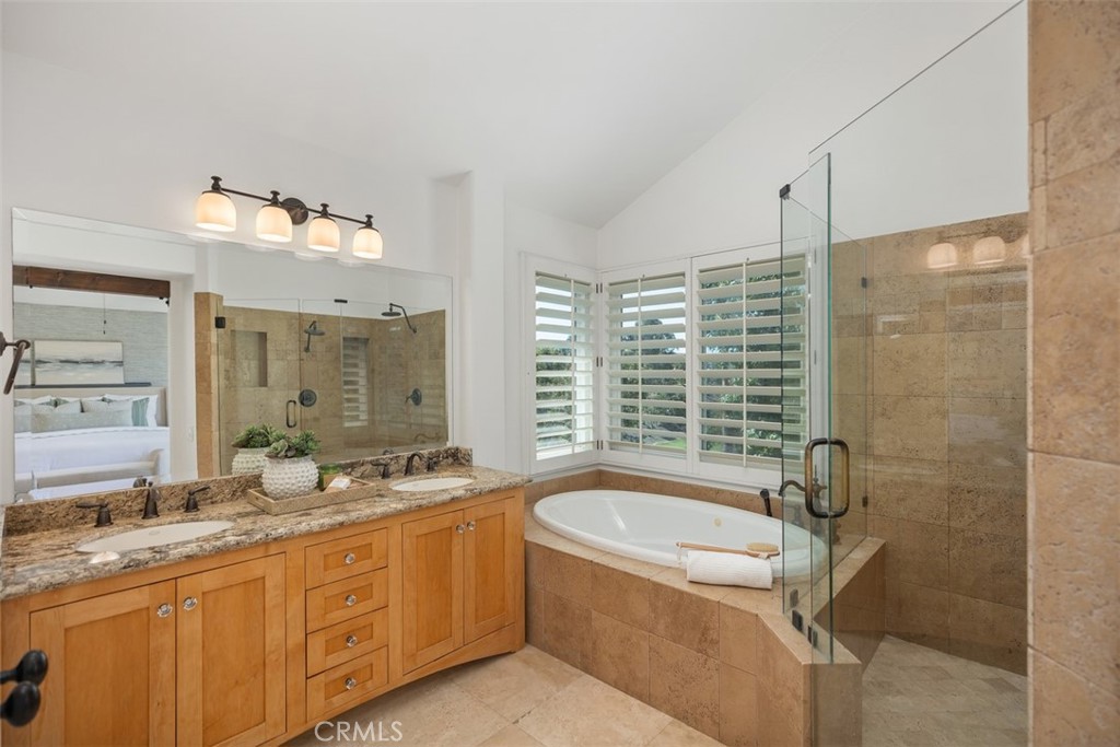6 Calella Laguna Niguel, CA 92677 - Photo 19 of 28 a bathroom with a granite countertop tub sink and mirror