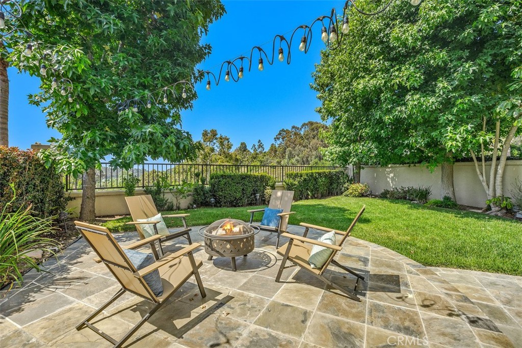 6 Calella Laguna Niguel, CA 92677 - Photo 27 of 28 a view of a patio with table and chairs and potted plants with wooden fence