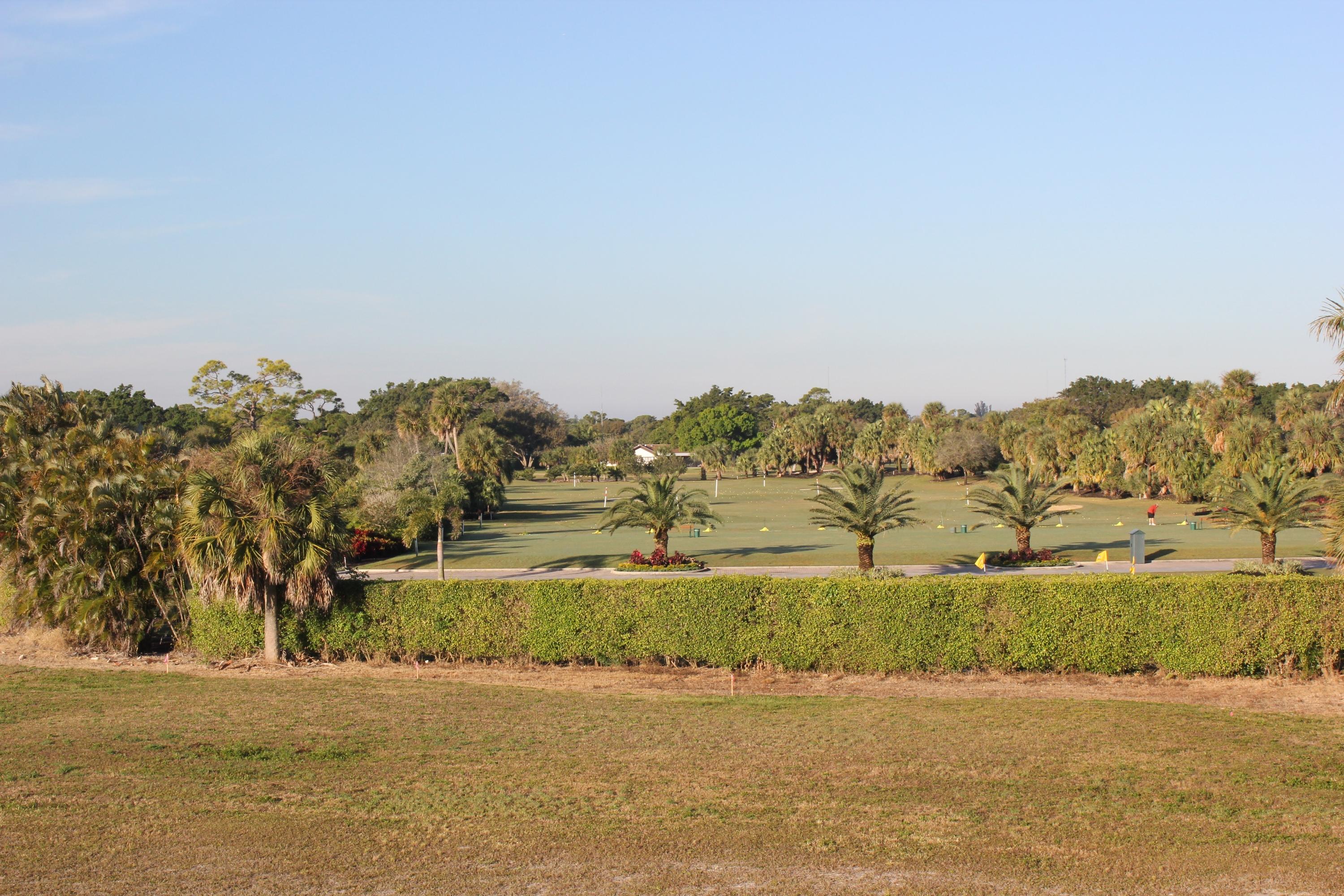 331 Orange Tree Drive Atlantis, FL 33462 - Photo 2 of 6 a view of a lake with a mountain