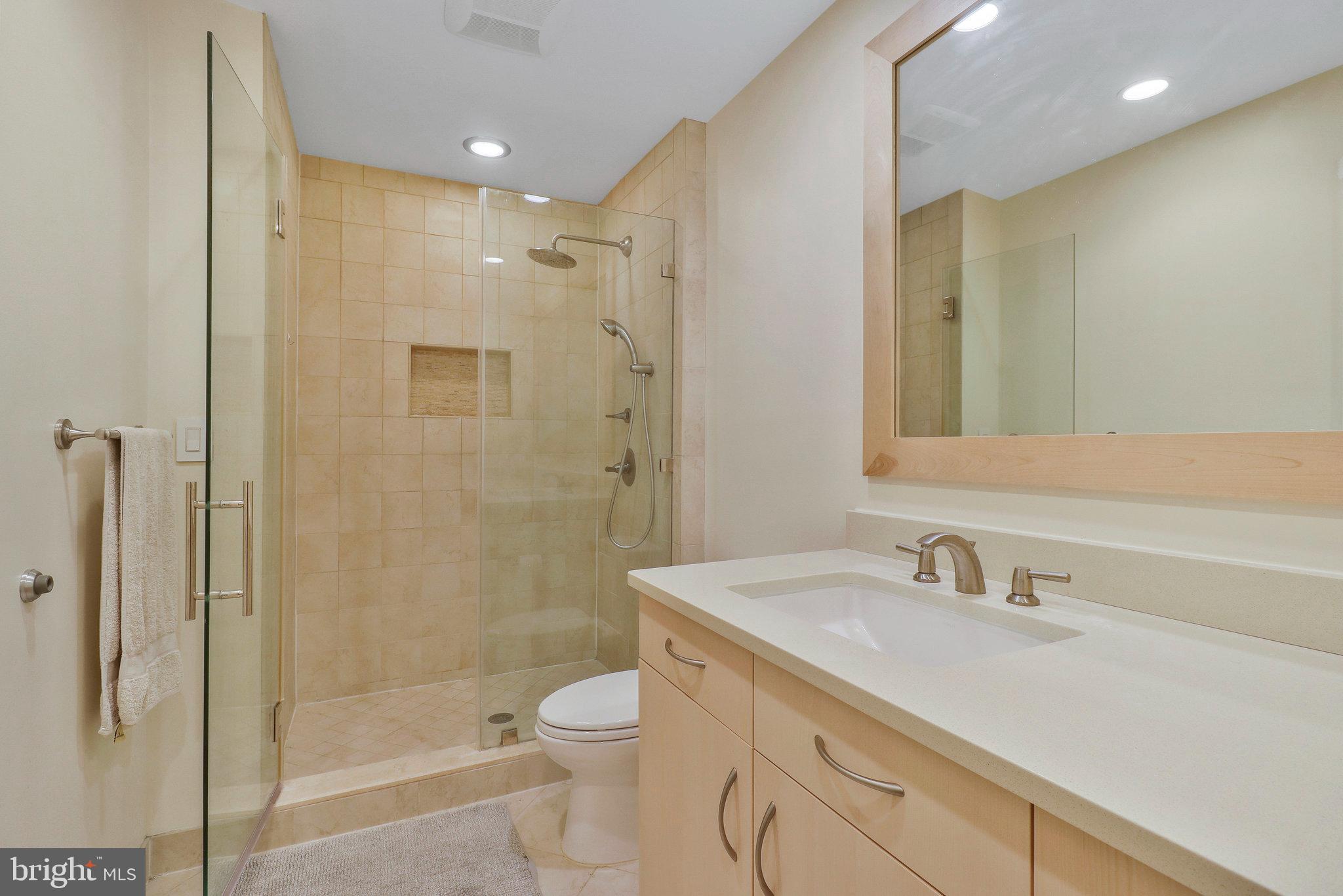 8543 Howell Road Bethesda, MD 20817 - Photo 14 of 24 a bathroom with a sink a toilet and shower