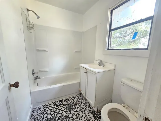 a bathroom with a bathtub sink and toilet