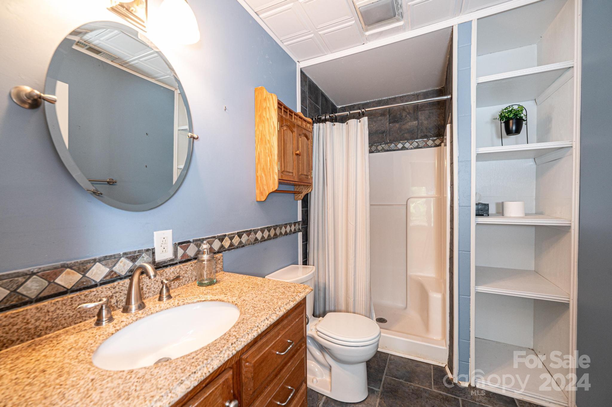 5366 Beacon Ridge Drive Granite Falls, NC 28630 - Photo 37 of 47 a bathroom with a granite countertop sink mirror and a toilet
