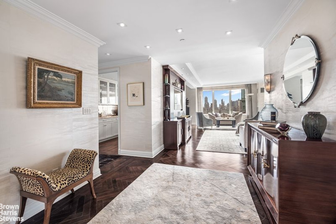 15 West 63rd Street, Unit 20B Manhattan, NY 10023 - Photo 3 of 14 a living room with furniture and a wooden floor