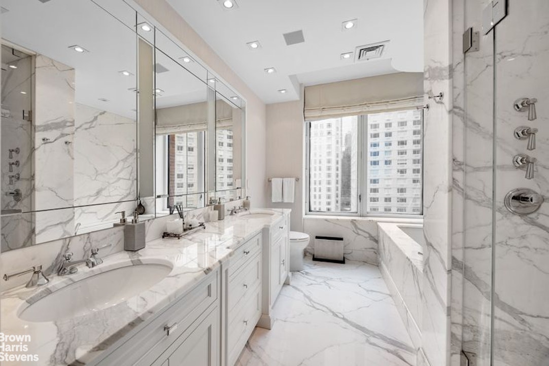 15 West 63rd Street, Unit 20B Manhattan, NY 10023 - Photo 9 of 14 a spacious bathroom with double vanity and a bathtub