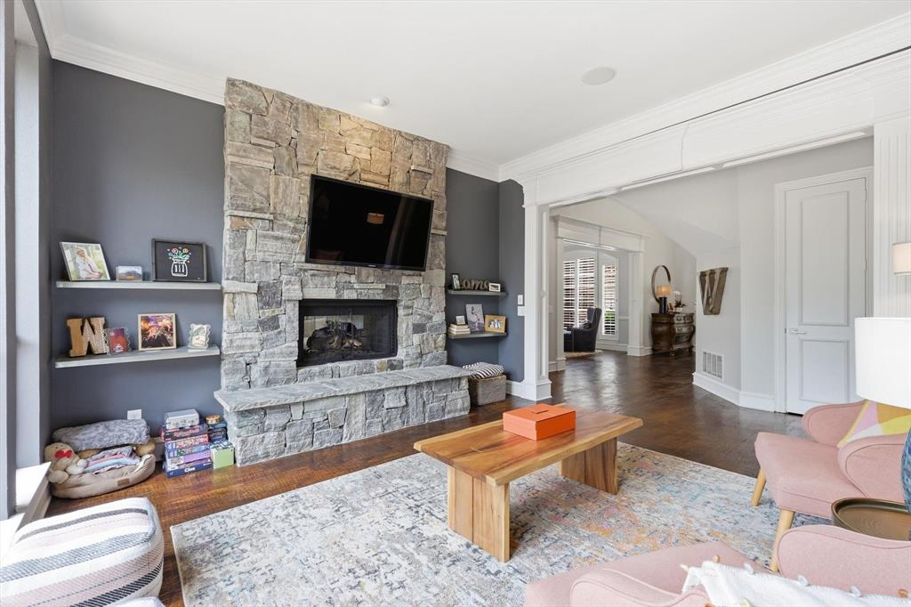 462 Copperstone Trail Coppell, TX 75019 - Photo 12 of 38 a living room with furniture a flat screen tv and a fireplace