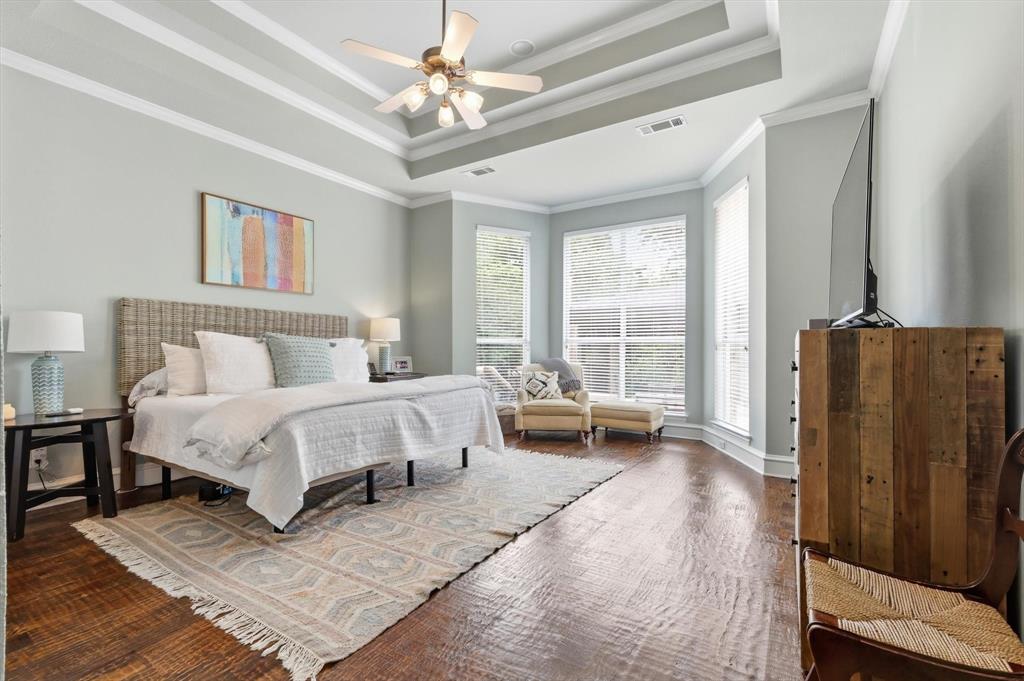 462 Copperstone Trail Coppell, TX 75019 - Photo 13 of 38 a spacious bedroom with a bed and a table