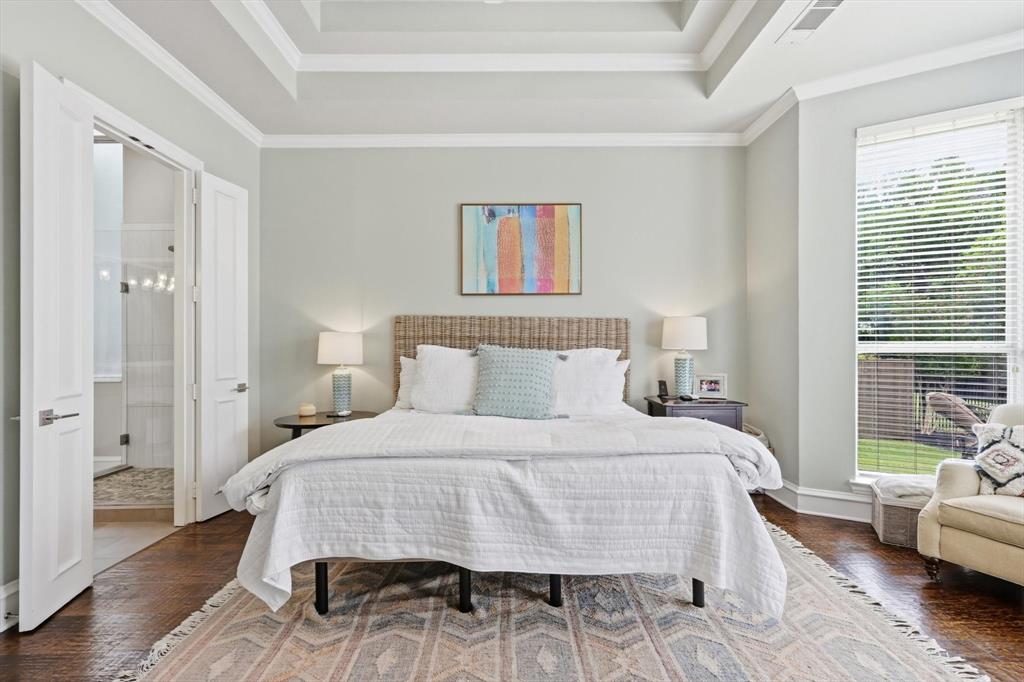 462 Copperstone Trail Coppell, TX 75019 - Photo 14 of 38 a bedroom with a bed and wooden floor