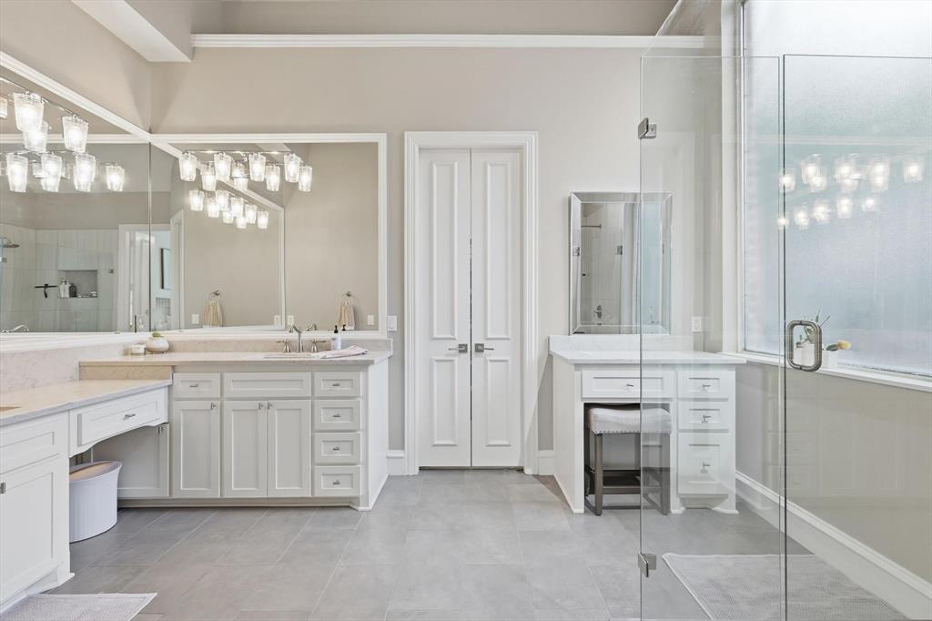 462 Copperstone Trail Coppell, TX 75019 - Photo 15 of 38 a spacious bathroom with a granite countertop sink mirror and a bathtub