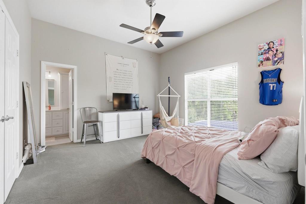 462 Copperstone Trail Coppell, TX 75019 - Photo 17 of 38 a bedroom with a bed and a flat screen tv