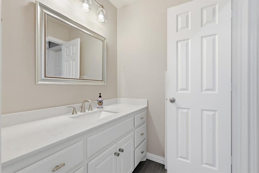 462 Copperstone Trail Coppell, TX 75019 - Photo 20 of 38 a bathroom with a sink and a mirror