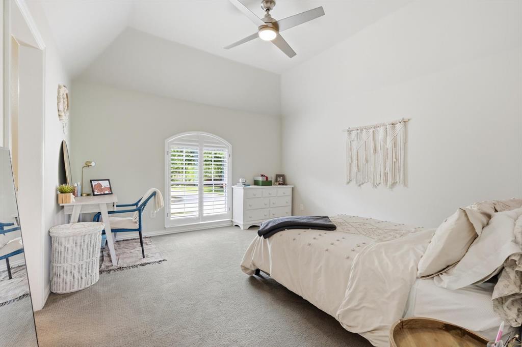 462 Copperstone Trail Coppell, TX 75019 - Photo 21 of 38 a bedroom with a bed and a chair